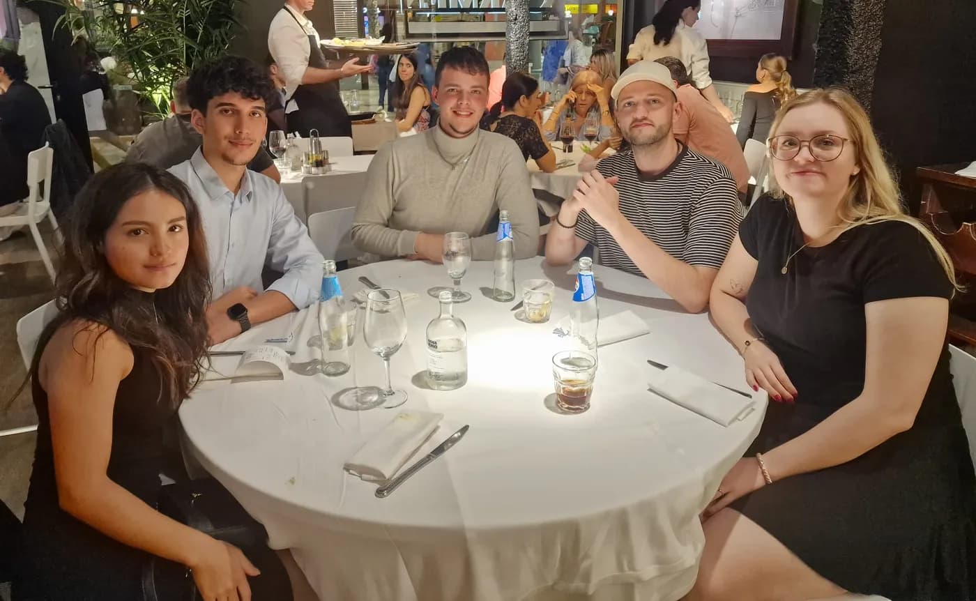 The Zaliza Marketing team with students on placement, having dinner around a table